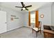 Cozy bedroom with gray walls, ceiling fan, carpeted floors, and a natural light-filled window at 8548 Scarsdale W Dr, Indianapolis, IN 46256