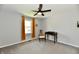 This bedroom features a ceiling fan, a window with curtains, a desk and chair at 8548 Scarsdale W Dr, Indianapolis, IN 46256