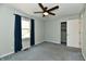 This bedroom features a ceiling fan, a window with curtains and a closet at 8548 Scarsdale W Dr, Indianapolis, IN 46256