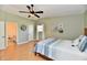This bedroom features a ceiling fan, a window and a door leading to a bathroom at 8548 Scarsdale W Dr, Indianapolis, IN 46256