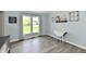 Bright dining room featuring a large window, hardwood floors, and neutral walls at 8548 Scarsdale W Dr, Indianapolis, IN 46256