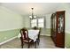 Formal dining room featuring hardwood floors, wainscoting, chandelier, and a large hutch at 8548 Scarsdale W Dr, Indianapolis, IN 46256