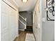 Inviting entryway with wood-look flooring, closet, stairs to the second floor, and front door with decorative glass at 8548 Scarsdale W Dr, Indianapolis, IN 46256