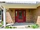 Close-up of the inviting front door with brick facade and decorative sidelights at 8548 Scarsdale W Dr, Indianapolis, IN 46256