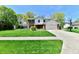 Charming two-story home with a well-maintained lawn and a classic brick facade at 8548 Scarsdale W Dr, Indianapolis, IN 46256
