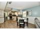 Eat-in kitchen with stainless steel appliances, modern cabinetry, and hardwood floors at 8548 Scarsdale W Dr, Indianapolis, IN 46256