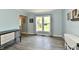 Bright living room featuring a large window, hardwood floors, neutral walls, and an accent piece of furniture at 8548 Scarsdale W Dr, Indianapolis, IN 46256