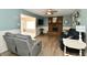 Cozy living room featuring a brick fireplace, hardwood floors, neutral paint, and modern furniture at 8548 Scarsdale W Dr, Indianapolis, IN 46256