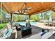 Backyard with pool view and covered patio seating, perfect for relaxing or entertaining guests at 8548 Scarsdale W Dr, Indianapolis, IN 46256