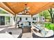 Covered outdoor seating area with comfortable furniture, ceiling fan, and view of the backyard at 8548 Scarsdale W Dr, Indianapolis, IN 46256