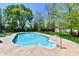Inviting backyard pool surrounded by lush greenery, offering a private and refreshing outdoor oasis at 8548 Scarsdale W Dr, Indianapolis, IN 46256