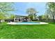Stunning backyard showcasing a swimming pool, covered patio, and a lush green lawn area at 8548 Scarsdale W Dr, Indianapolis, IN 46256