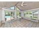 Bright sunroom featuring large windows with tile flooring and backyard pool views at 8548 Scarsdale W Dr, Indianapolis, IN 46256