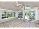 Bright sunroom with tiled flooring and views of the backyard pool at 8548 Scarsdale W Dr, Indianapolis, IN 46256