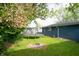 Back yard features a trampoline and a burnt pit, trees, and grass at 8814 W 30Th St, Indianapolis, IN 46234