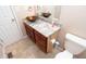 Bathroom features a brown basin sink, granite counters, and wood vanity at 8814 W 30Th St, Indianapolis, IN 46234