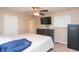Bedroom with ceiling fan, TV, dresser, safe, and carpet at 8814 W 30Th St, Indianapolis, IN 46234