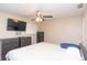 Bedroom with a ceiling fan, tv, dresser, and safe at 8814 W 30Th St, Indianapolis, IN 46234