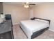 Bedroom with ceiling fan, TV, bed, dresser, and carpet at 8814 W 30Th St, Indianapolis, IN 46234