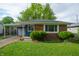 Cozy single-story home featuring a brick facade, blue wood siding, and a convenient carport at 8814 W 30Th St, Indianapolis, IN 46234