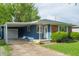 Charming one-story house showcasing blue siding, brick accents, and a convenient covered carport at 8814 W 30Th St, Indianapolis, IN 46234