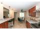 Charming kitchen with dark wood cabinets, granite counters, stainless steel appliances, and an adjacent breakfast nook at 8814 W 30Th St, Indianapolis, IN 46234