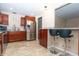 Bright, airy kitchen with stainless steel refrigerator, granite countertops, and a breakfast bar overlooking the living area at 8814 W 30Th St, Indianapolis, IN 46234