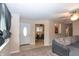 Open living space featuring plush carpeting, a comfortable gray sofa, and a view into the dining area at 8814 W 30Th St, Indianapolis, IN 46234