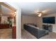 Cozy living room with plush carpeting, a large gray sectional, and a partial view into the kitchen at 8814 W 30Th St, Indianapolis, IN 46234