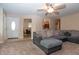 Inviting living space featuring plush carpeting, a gray sectional sofa, and a peek into the dining area at 8814 W 30Th St, Indianapolis, IN 46234