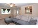 Inviting living room featuring a large sectional sofa, neutral walls, and natural light from the large windows at 8814 W 30Th St, Indianapolis, IN 46234