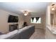 Comfortable living room showcasing a modern entertainment center, cozy carpet, and contemporary ceiling fan at 8814 W 30Th St, Indianapolis, IN 46234
