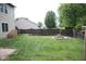 Large backyard with privacy fence, storage shed, firepit, and grassy area at 8912 Hosta Way, Indianapolis, IN 46113