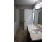 Bathroom featuring a single sink vanity, tile floor and closet access at 8912 Hosta Way, Indianapolis, IN 46113