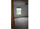 View of carpeted bedroom through doorway with a window, bringing in natural light at 8912 Hosta Way, Indianapolis, IN 46113
