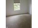 Bright bedroom featuring a window with natural light and neutral carpeting at 8912 Hosta Way, Indianapolis, IN 46113
