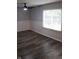 Bedroom with new gray vinyl flooring, white trim, and large window at 8912 Hosta Way, Indianapolis, IN 46113