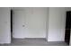 Bedroom with neutral-colored walls, carpet, and two doorways at 8912 Hosta Way, Indianapolis, IN 46113