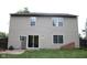 View of the home's back exterior featuring sliding glass doors and various windows at 8912 Hosta Way, Indianapolis, IN 46113