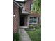 Inviting front entrance with a brick facade, covered porch, and manicured landscaping at 8912 Hosta Way, Indianapolis, IN 46113