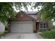 Charming two-story brick home with a well-maintained lawn and attached two-car garage at 8912 Hosta Way, Indianapolis, IN 46113