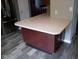 Kitchen island featuring a light countertop and dark wood cabinets at 8912 Hosta Way, Indianapolis, IN 46113