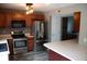 Well-lit kitchen featuring stainless steel appliances, wood cabinets, and updated flooring at 8912 Hosta Way, Indianapolis, IN 46113