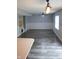 Living room with decorative trim, neutral paint, wood-look floors and ceiling fan at 8912 Hosta Way, Indianapolis, IN 46113