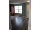 Living area with new dark-toned vinyl flooring, large window, and built-in cabinets at 8912 Hosta Way, Indianapolis, IN 46113