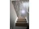 Staircase with gray-toned vinyl flooring leading to carpeted steps with handrail at 8912 Hosta Way, Indianapolis, IN 46113