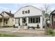 Charming home with a welcoming front porch, complemented by landscaping and a well-manicured lawn at 940 E Pleasant Run Parkway North Dr, Indianapolis, IN 46203