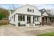 Charming home featuring a welcoming front porch, complemented by beautiful landscaping and a well-maintained exterior at 940 E Pleasant Run Parkway North Dr, Indianapolis, IN 46203