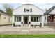 Charming home with a white brick facade, manicured landscaping, and welcoming front porch at 940 E Pleasant Run Parkway North Dr, Indianapolis, IN 46203