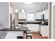 Bright kitchen with white cabinets, stainless steel appliances, breakfast bar and sleek black countertops at 940 E Pleasant Run Parkway North Dr, Indianapolis, IN 46203
